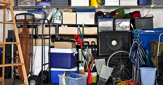 Storage unit filled with household items, sports equipment and electronics